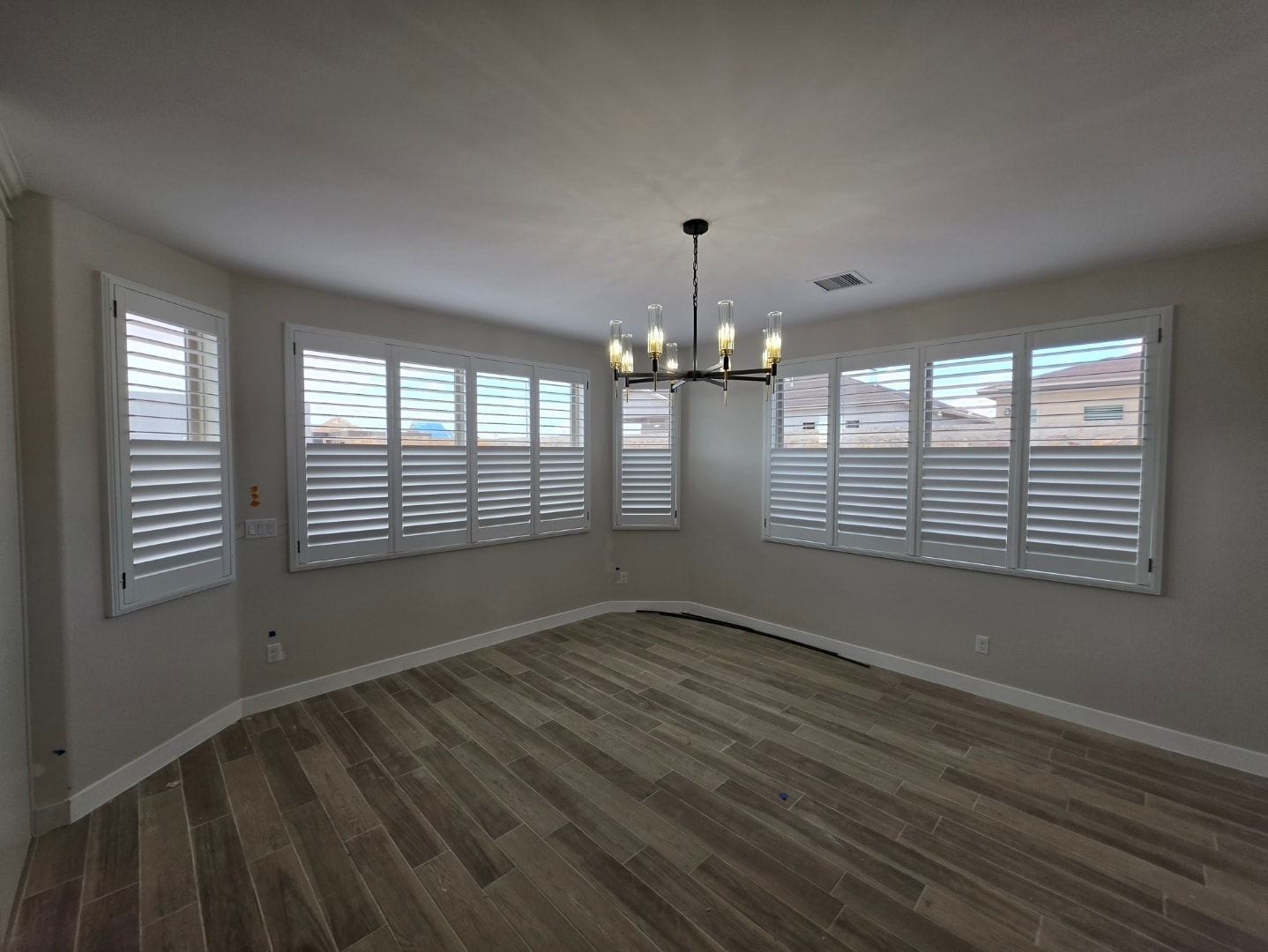 Plantation shutters wrapping a curved dining room