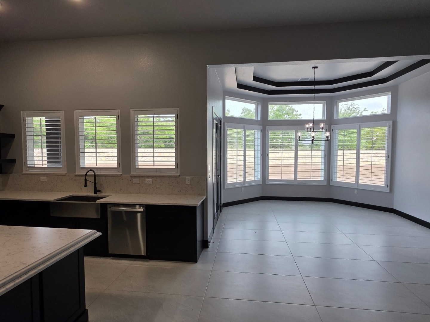 White plantation shutters on kitchen windows and bay window
