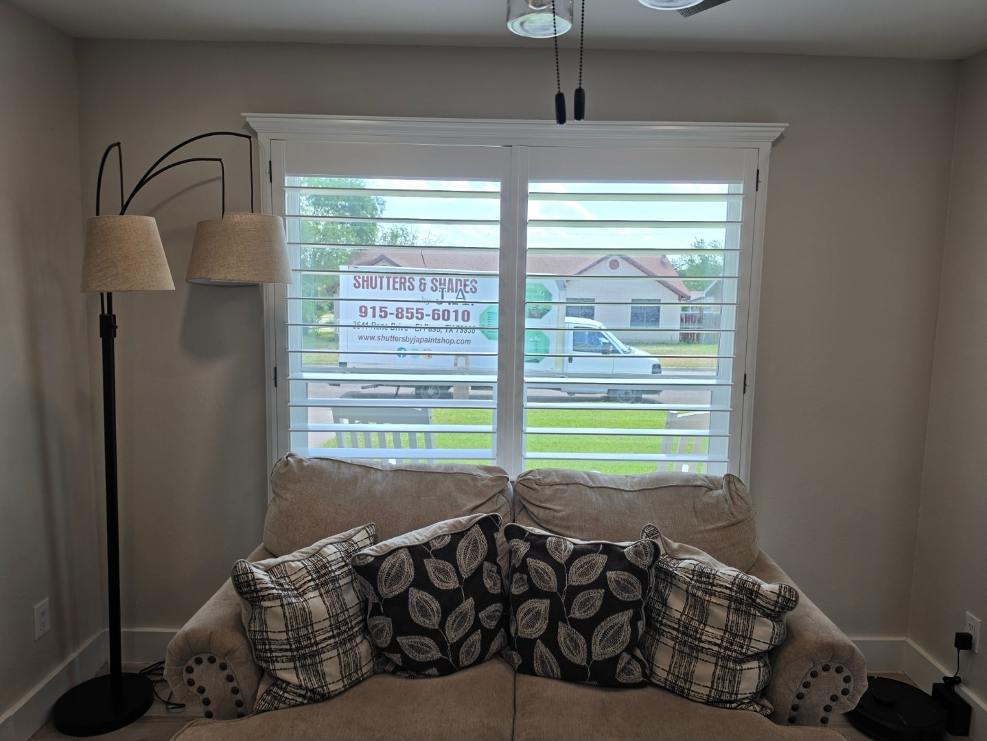 Professional window treatment installer at work